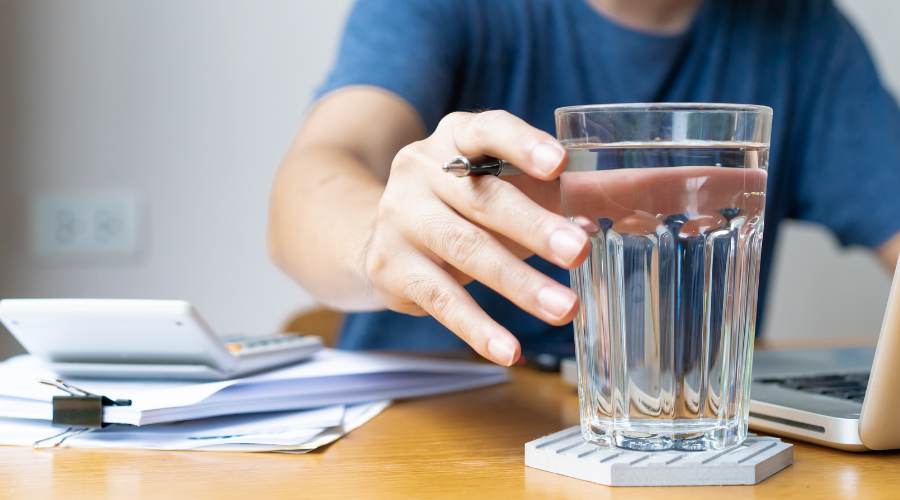 health benefits of water - man reaching for a glass of water